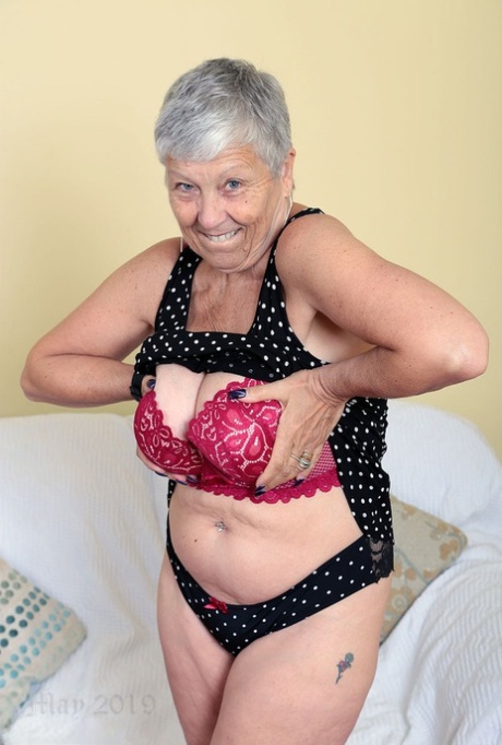 Sexy granny Savana flashes upskirt underwear before unleashing her large boobs