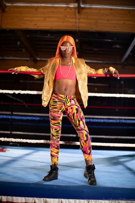 Black girl unveils her athletic body while in a boxing ring