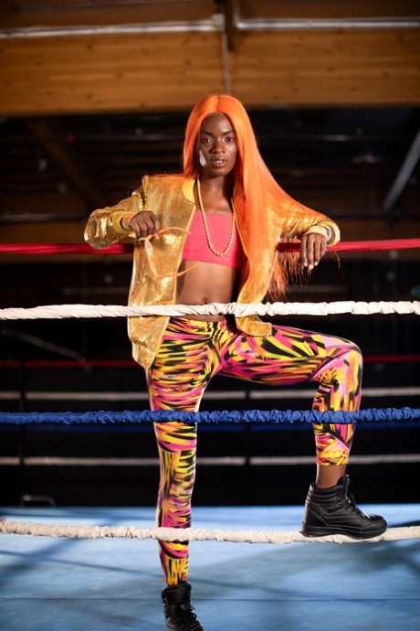 Black girl unveils her athletic body while in a boxing ring