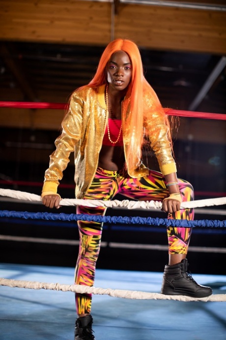 Black girl unveils her athletic body while in a boxing ring