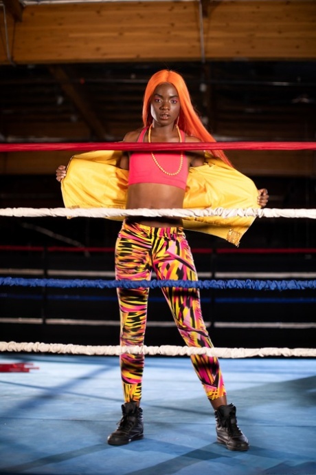 Black girl unveils her athletic body while in a boxing ring