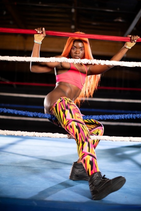 Black girl unveils her athletic body while in a boxing ring