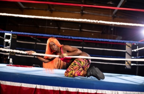 Black girl unveils her athletic body while in a boxing ring