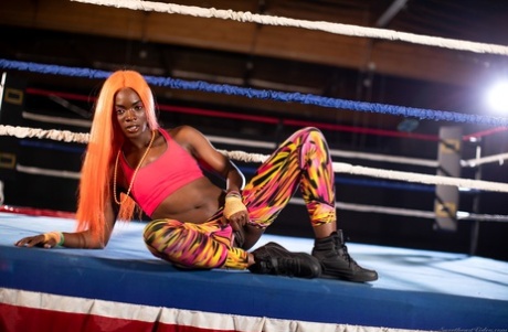 Black girl unveils her athletic body while in a boxing ring