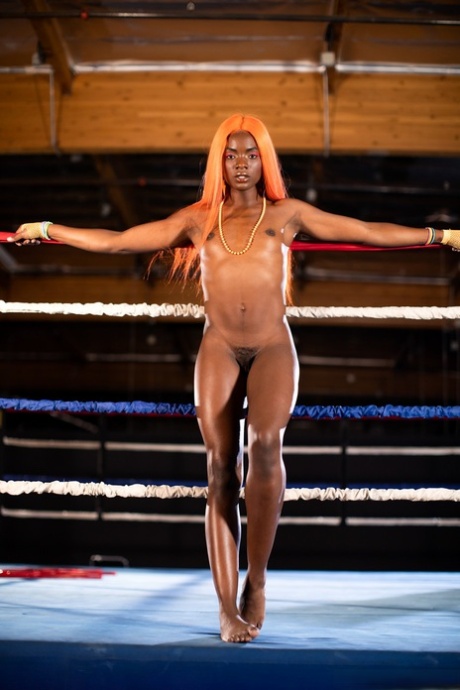 Black girl unveils her athletic body while in a boxing ring