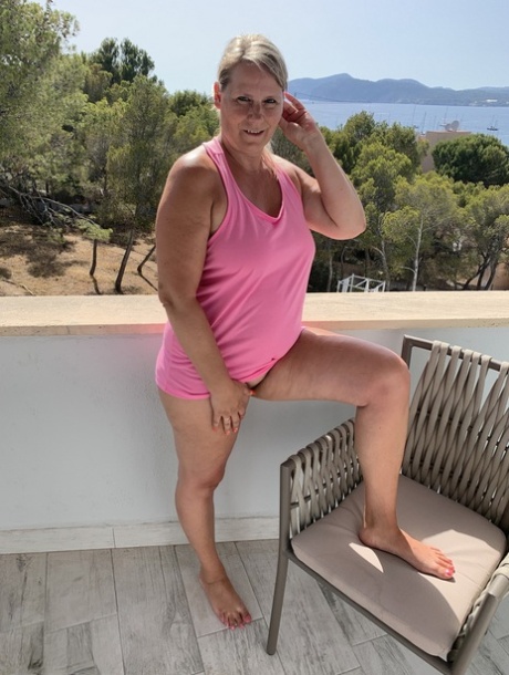 Thick older blonde twerks her big ass on a balcony after exposing herself