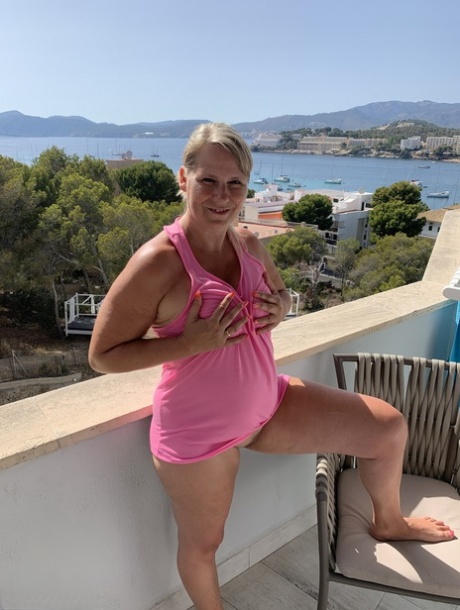 Thick older blonde twerks her big ass on a balcony after exposing herself