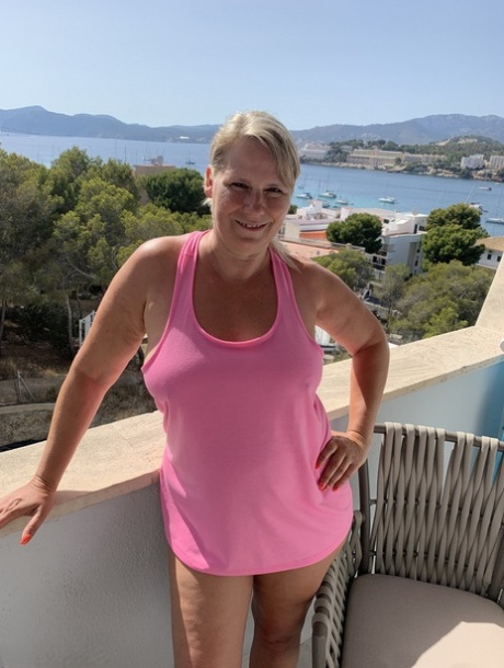 Thick older blonde twerks her big ass on a balcony after exposing herself