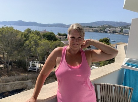 Thick older blonde twerks her big ass on a balcony after exposing herself