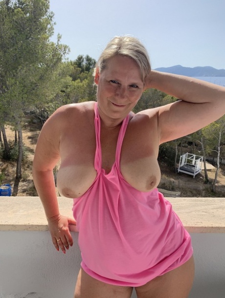 Thick older blonde twerks her big ass on a balcony after exposing herself