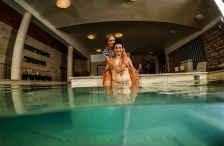 Old and young lesbians have sex in an indoor swimming pool