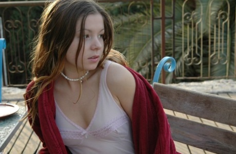 Charming young girl teases in lingerie after a glass of OJ for breakfast