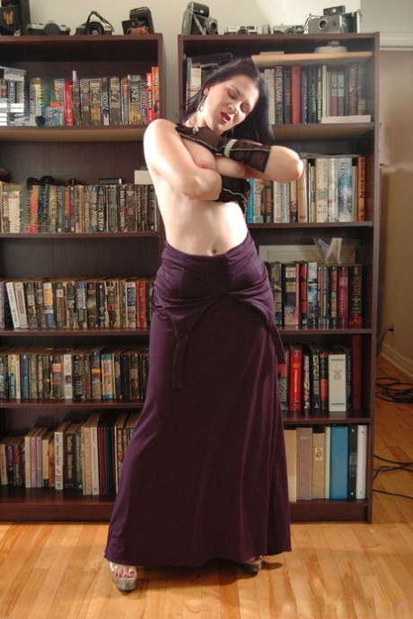 Amateur model Mina Gorey strips naked in gloves and heels afore a bookcase