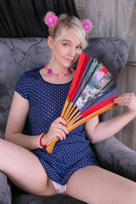Adorable teen Kapri showcases her smooth twat with flowers in her blonde hair