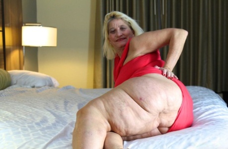 Obese blonde granny Amber Conners hitches her dress up and over her fat ass
