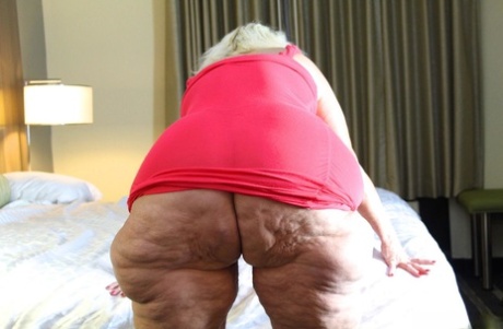 Obese blonde granny Amber Conners hitches her dress up and over her fat ass