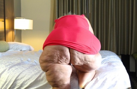 Obese blonde granny Amber Conners hitches her dress up and over her fat ass