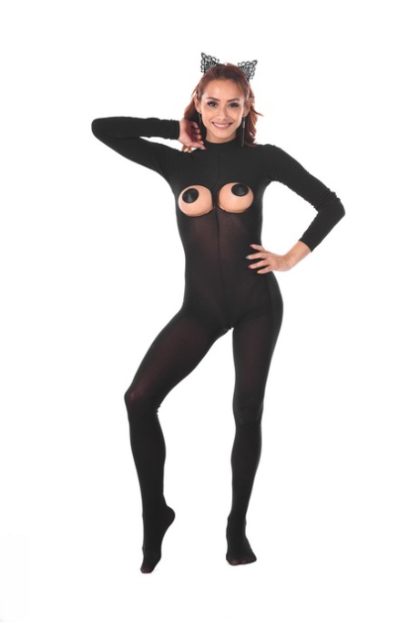 Redheaded Latina female toys her asshole after removing a bodystocking