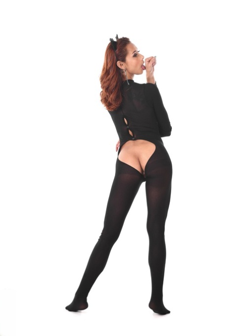Redheaded Latina female toys her asshole after removing a bodystocking