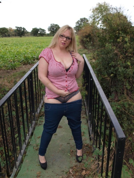 Amateur BBW Sindy Bust exposes her big boobs and twat on a countryside bridge