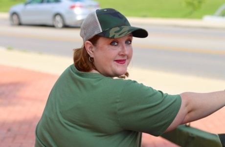 Obese amateur Goddess Pear models for a SFW shoot on an artillery gun in camo