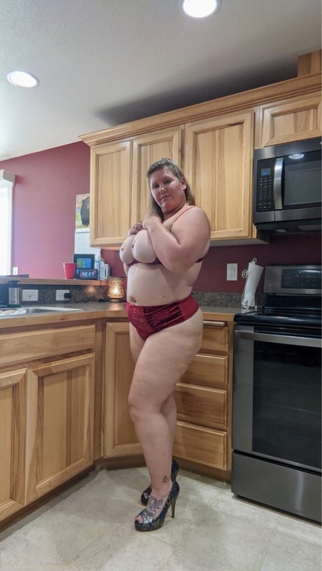 Amateur woman Busty Kris Ann shows her big tits and butt in her kitchen