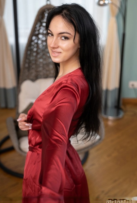 Dark-haired teen Corinna displays her edible pussy while totally naked