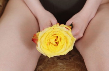 Pale redhead Jia Lissa teases her landing strip pussy with a yellow rose