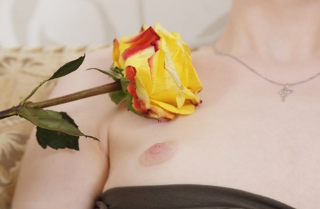 Pale redhead Jia Lissa teases her landing strip pussy with a yellow rose