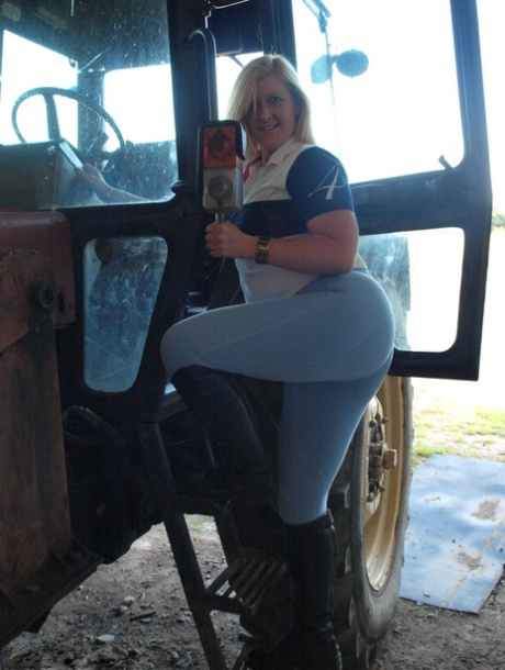 Amateur BBW Samantha strips to knee-high black boots on a farm tractor