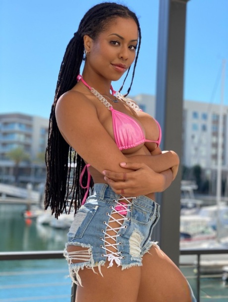 Ebony teen Kira Noir models a bikini before a ball sucking and ass eating BJ