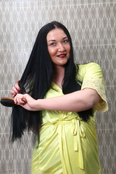 Curvy 30 plus brunette Vanessa Vaughn brushes her long hair before bathing
