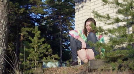 Pretty girl Vika Lita pulls down her jeans to pee amid saplings