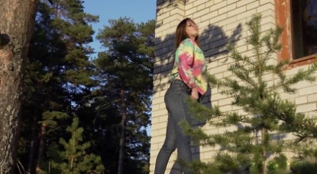 Pretty girl Vika Lita pulls down her jeans to pee amid saplings