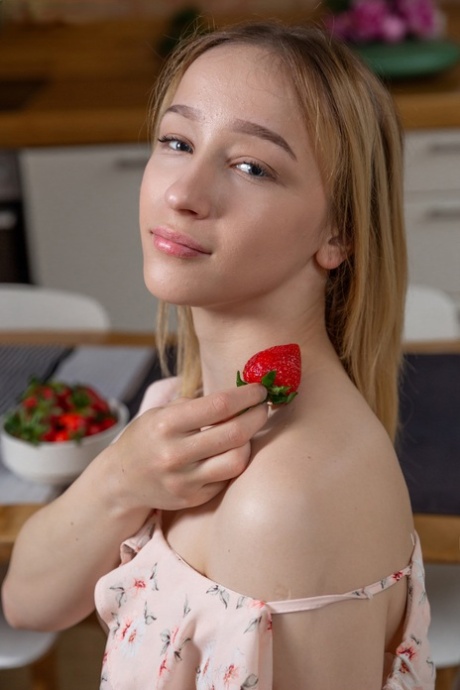 Sweet teen Moreen takes off her dress to reveal her great body in a kitchen