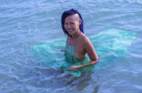 Asian teen Sweet Julie emerges from the ocean to go bare naked