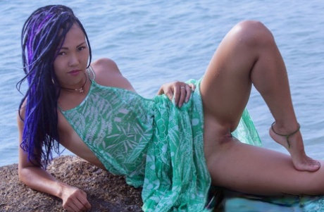 Asian teen Sweet Julie emerges from the ocean to go bare naked