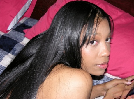 Pretty black girl Eden West makes her nude modelling debut on a bed