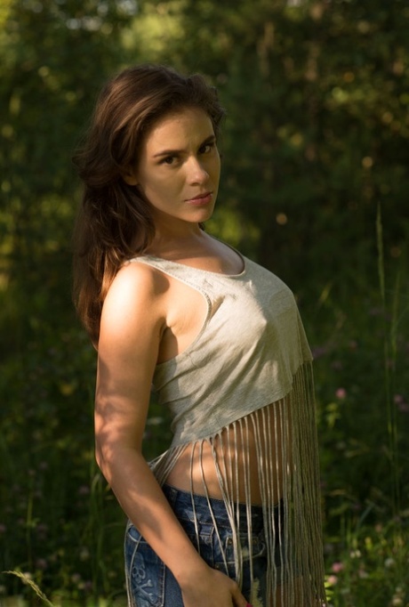 Brunette teen Leda gets naked in footwear while out in the woods
