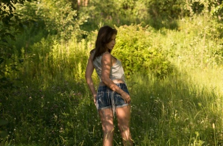 Brunette teen Leda gets naked in footwear while out in the woods