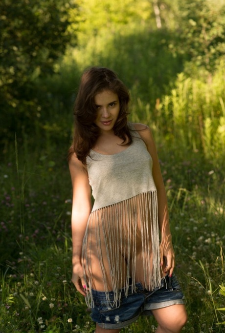 Brunette teen Leda gets naked in footwear while out in the woods