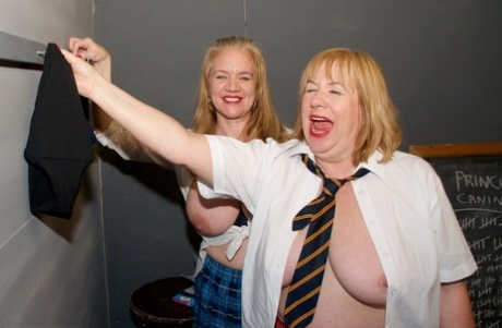 Two coeds and their teacher show their tits and twats in a classroom
