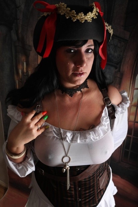 Dark-haired woman Sara Banks sports handcuffs while outfitted in pirate attire