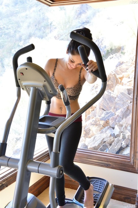 Pretty brunette Nicki exercises before masturbating with a vibrator