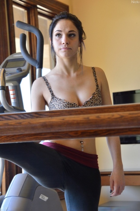 Pretty brunette Nicki exercises before masturbating with a vibrator