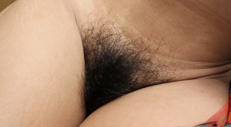 Skinny teen Asian Gi spreads naked to flaunt her very hairy pussy up close