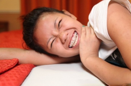 Petite Filipina teen Altea gets naked atop a bed for her sugar daddy