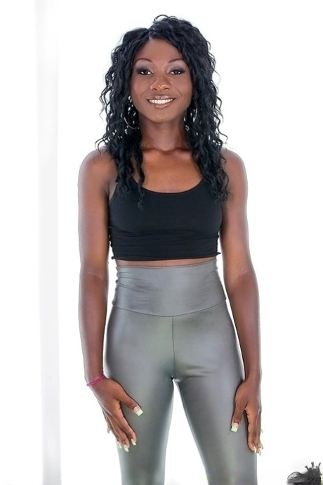 Ebony sugar in silver leggings undressing and exposing her ass