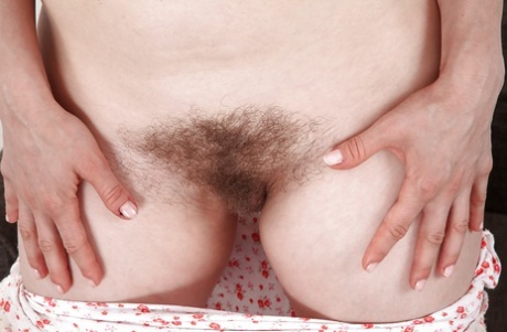 Fuckable mature lady with hairy twat undressing and spreading her long legs