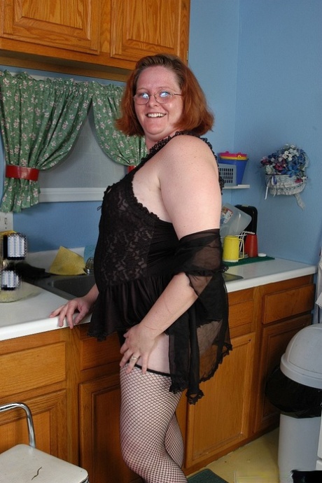 Fat redhead mature MILF Adrienne showcasing her big ass in stockings
